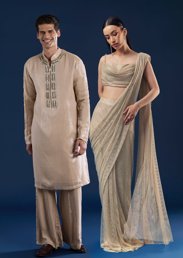 Grand Celebration Couple Set – Gold Ready-Pleated Satin Saree with Stone Detailing for Her And Beige Embroidered Kurta Jacket Set for Him