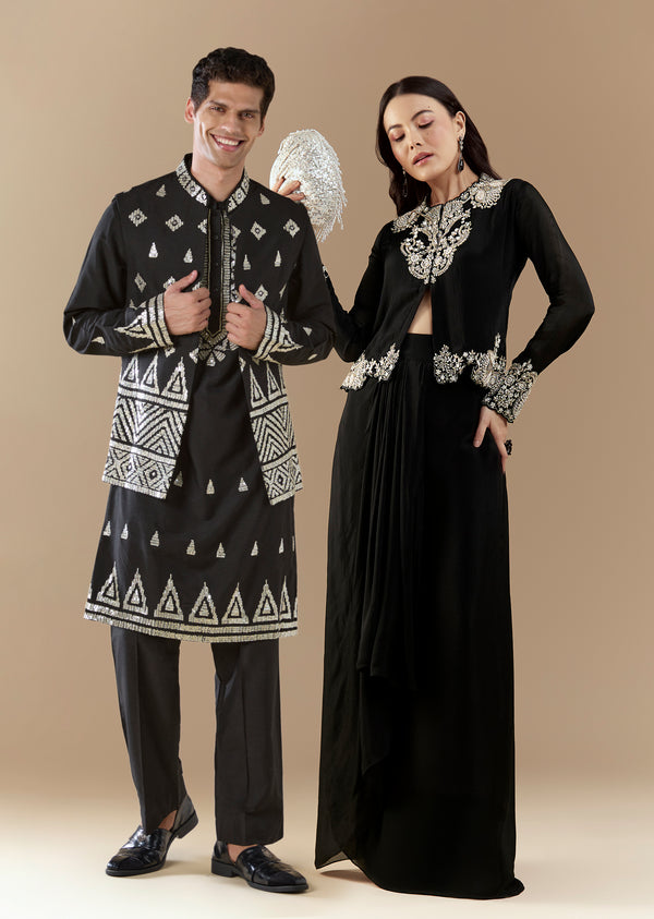 Statement Black Modern Couple Set – Black Chinon Crop Top Skirt Set For Her And Black Foil Applique Jacket Kurta Set For Him
