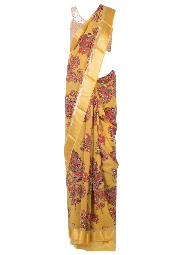Amber yellow saree in satin with big floral print only on Kalki