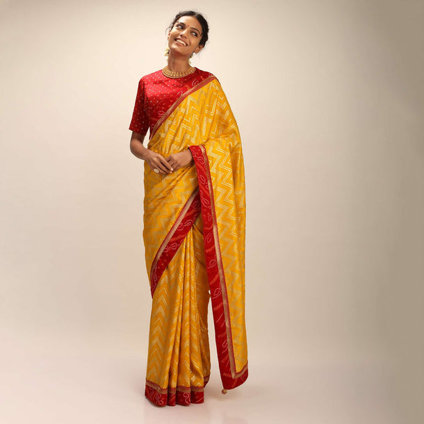 Amber Yellow Saree In Silk With Lurex Woven Chevron Design And Red Bandhani Border Along With Unstitched Blouse