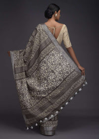 Ash Grey Saree In Linen With Batik Printed Buttis And Zari Weaved Border Online - Kalki Fashion