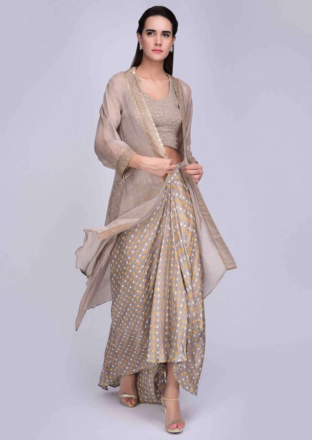 Beige crop top and jacket with a front short back long fancy draped skirt only on Kalki