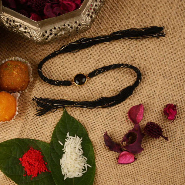 Black Braided Rakhi In Gold And Black Thread Work Is Further Enhanced In Semi-Precious Stone