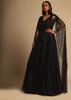 Black Gown In Sequins Embellished Net With Ruching In The Front, Sheer Sides And Net Cape On Each Shoulder