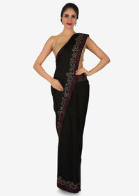 Black satin silk saree with unstitched blouse adorn in kundan embroidery work only on Kalki