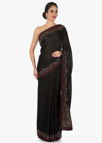 Black satin silk saree with unstitched blouse adorn in kundan embroidery work only on Kalki