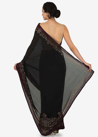 Black satin silk saree with unstitched blouse adorn in kundan embroidery work only on Kalki