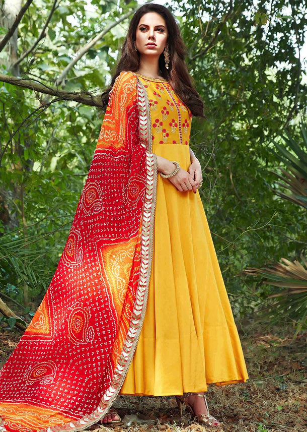 Bright yellow anarkali suit with embroidered bodice and bandhani dupatta