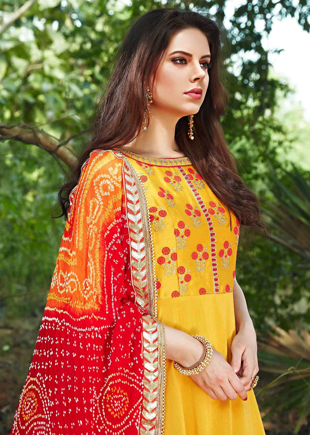 Bright yellow anarkali suit with embroidered bodice and bandhani dupatta