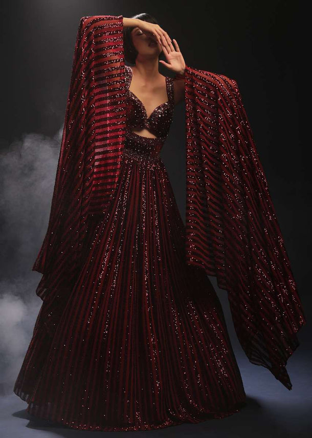 Burgundy Gown In Sequins Embellished Net With Attached Cape And Cut Dana Accented Front Cut Bodice