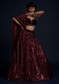 Burgundy Lehenga Embellished In Sequins With A Velvet Crop Top And Matching Belt Bag