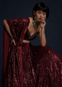 Burgundy Lehenga Embellished In Sequins With A Velvet Crop Top And Matching Belt Bag