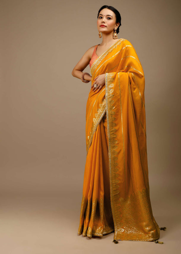 Cadmium Yellow Saree In Dola Silk With Lurex Woven Stripes On The Pallu And Geometric Floral Motifs On The Pleats