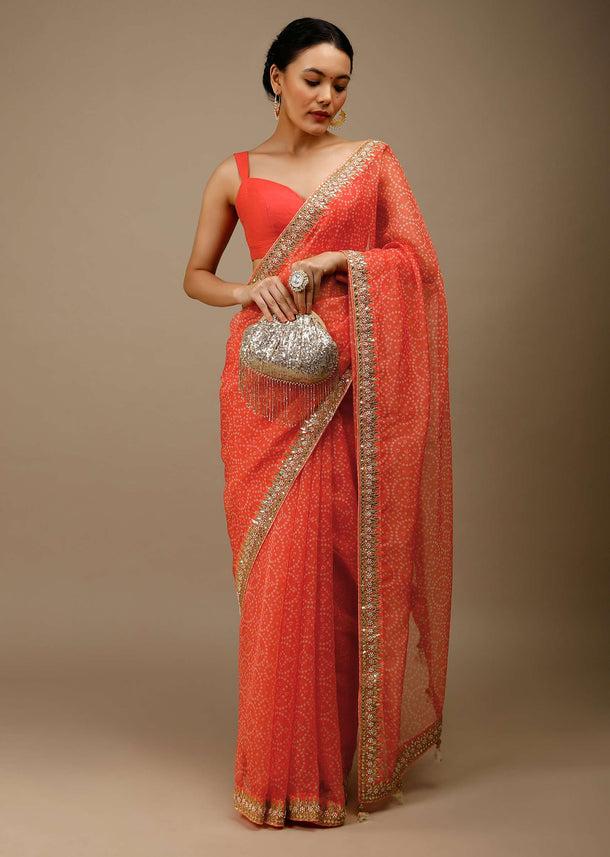 Camelia Orange Saree In Organza With Bandhani Jaal And Gotta Patti Embroidered Floral Motifs On The Border