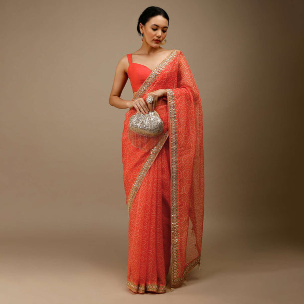 Camelia Orange Saree In Organza With Bandhani Jaal And Gotta Patti Embroidered Floral Motifs On The Border