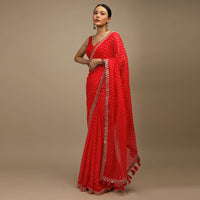 Coral Red Saree In Organza With Bandhani Buttis And Gotta Patti Embroidered Floral Motifs On The Border