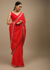 Coral Red Saree In Organza With Bandhani Buttis And Gotta Patti Embroidered Floral Motifs On The Border