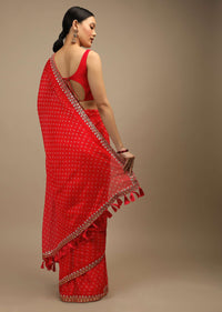 Coral Red Saree In Organza With Bandhani Buttis And Gotta Patti Embroidered Floral Motifs On The Border