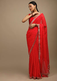 Coral Red Saree In Organza With Bandhani Buttis And Gotta Patti Embroidered Floral Motifs On The Border