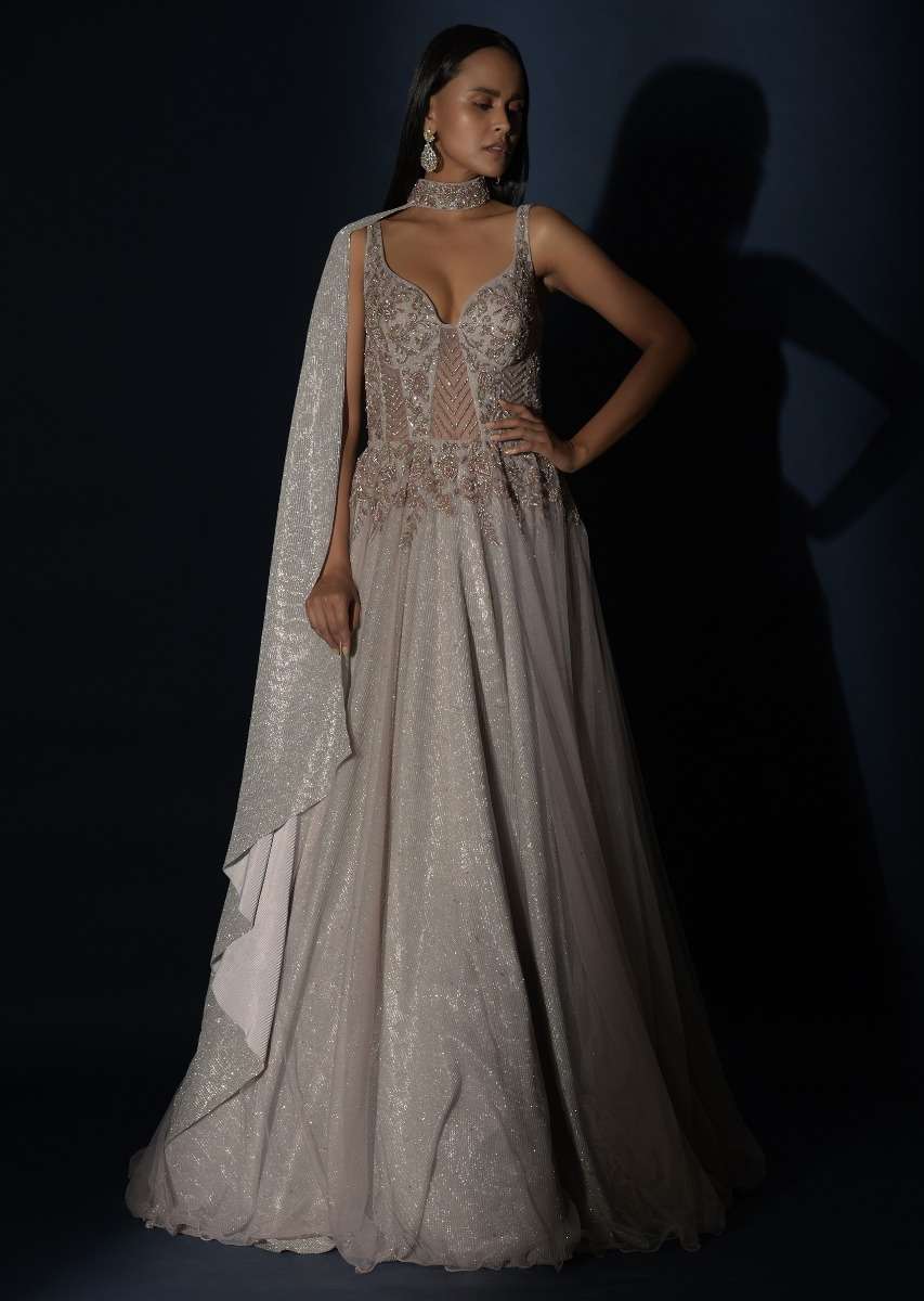 Champagne Embellished Gown With Plunging Neckline And A Fancy Choker With Attached Cape