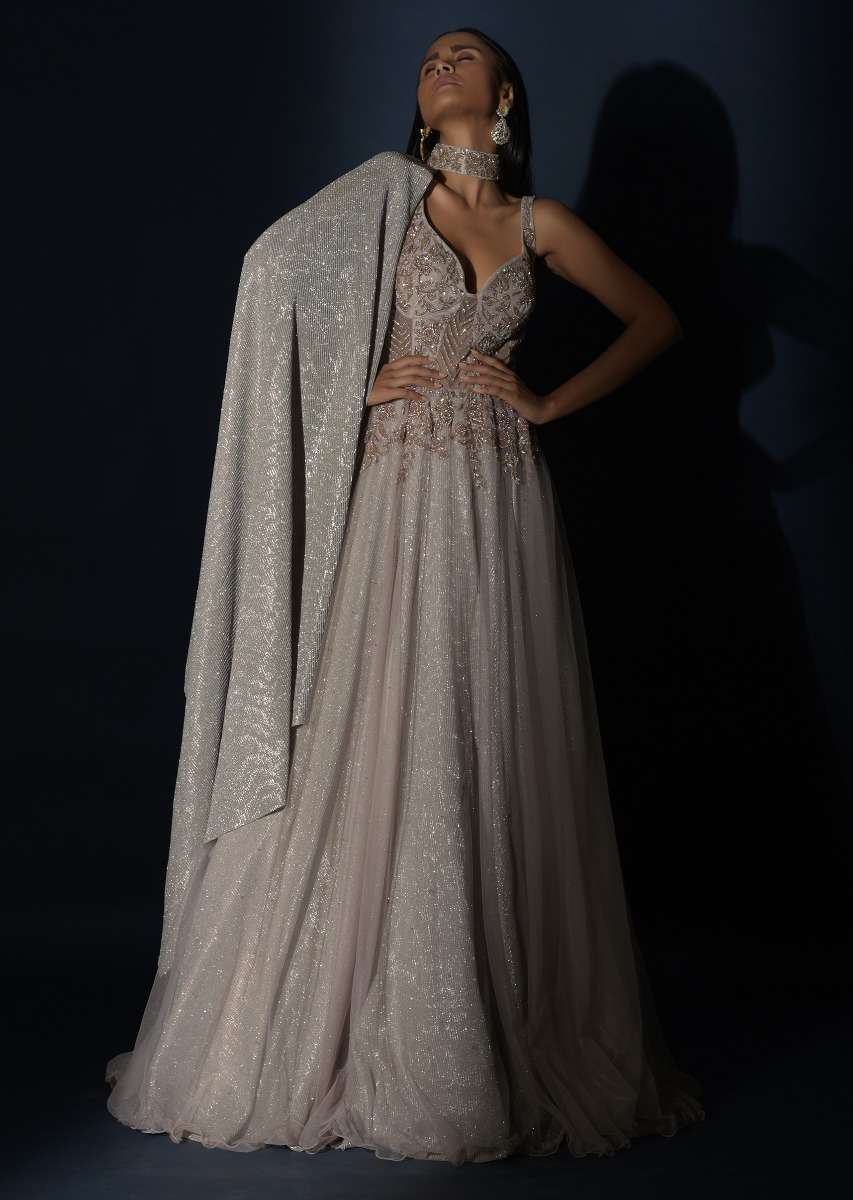 Champagne Embellished Gown With Plunging Neckline And A Fancy Choker With Attached Cape