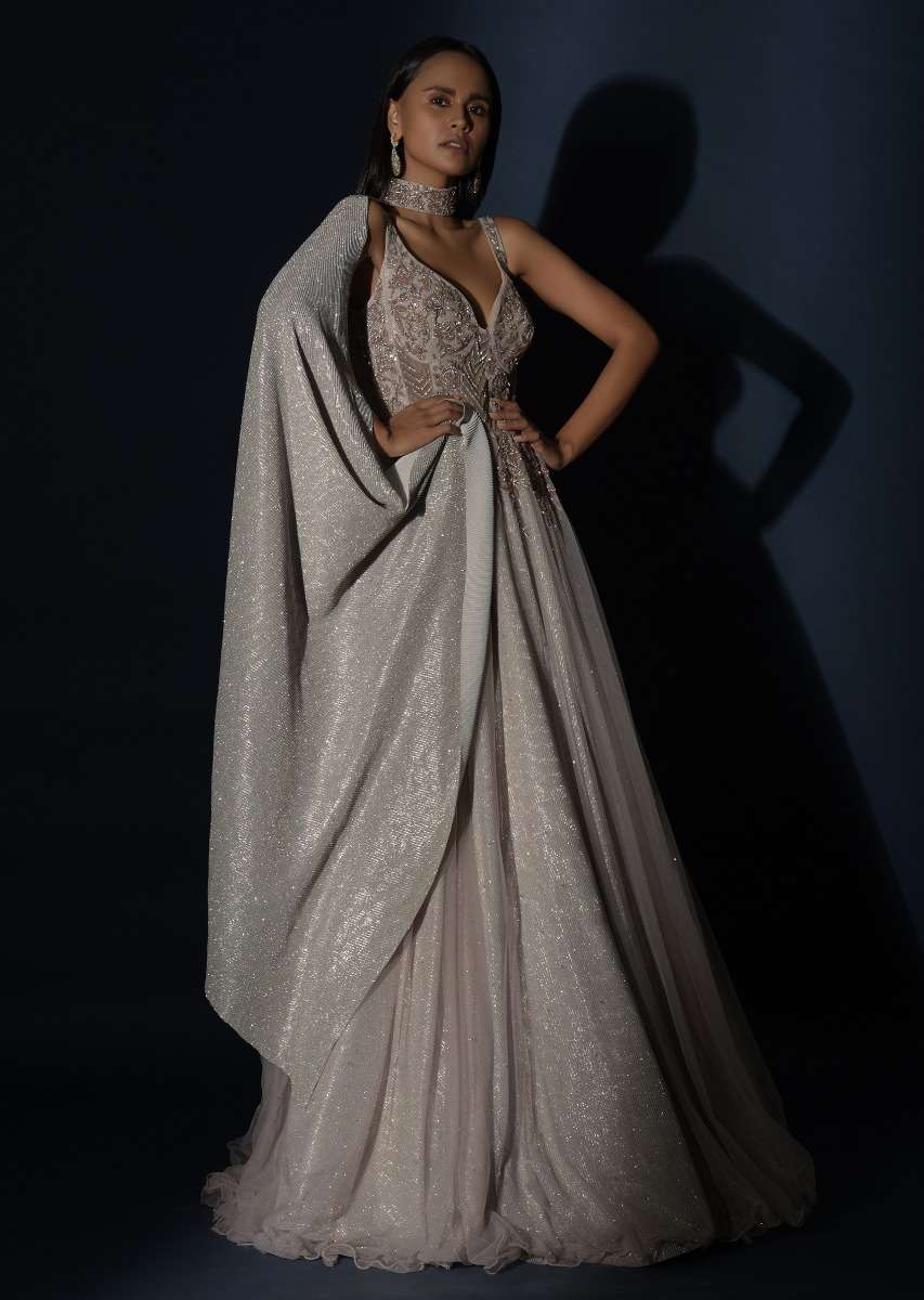 Champagne Embellished Gown With Plunging Neckline And A Fancy Choker With Attached Cape