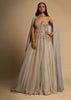 Champagne Embellished Gown With Plunging Neckline And A Fancy Choker With Attached Cape