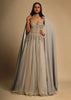 Champagne Embellished Gown With Plunging Neckline And A Fancy Choker With Attached Cape