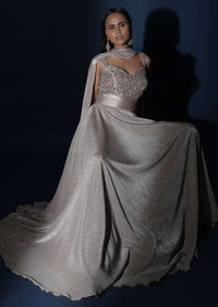 Champagne Gown In Crushed Shimmer With An Embellished Bodice Highlighting The Waistline And Fancy Cape