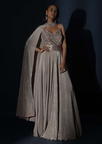 Champagne Gown In Crushed Shimmer With An Embellished Bodice Highlighting The Waistline And Fancy Cape