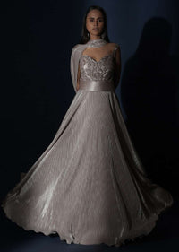 Champagne Gown In Crushed Shimmer With An Embellished Bodice Highlighting The Waistline And Fancy Cape