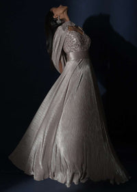 Champagne Gown In Crushed Shimmer With An Embellished Bodice Highlighting The Waistline And Fancy Cape