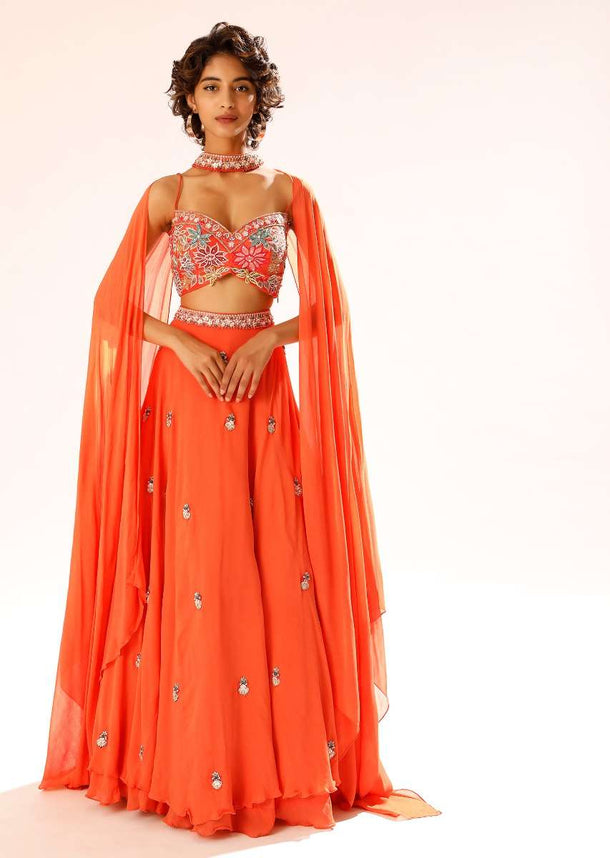 Coral Lehenga Choli With 3D Resham Embroidered Flowers And Matching Choker With Attached Cape Online - Kalki Fashion