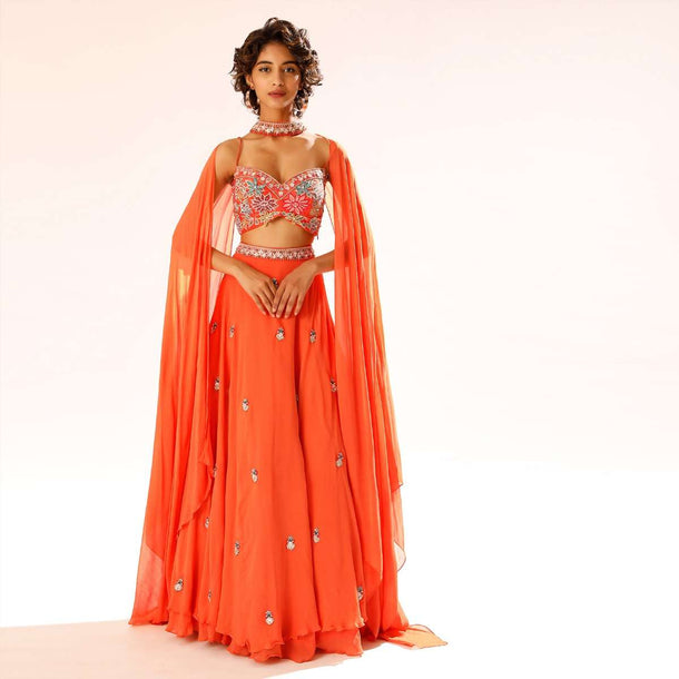 Coral Lehenga Choli With 3D Resham Embroidered Flowers And Matching Choker With Attached Cape Online - Kalki Fashion