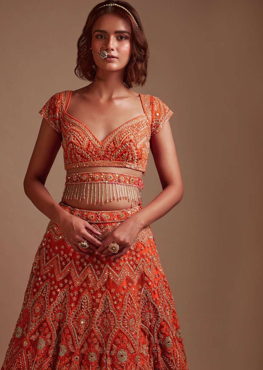 Coral Orange Lehenga Choli In Net With Mirror And Sequins Embroidered Floral And Mughal Embroidery Along With Belt Detailing