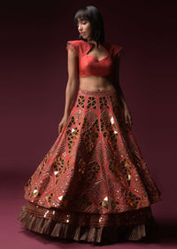 Coral Lehenga With Hand Embroidered Geometric Mirror Work And Plain Raw Silk Choli With Tassels On The Sleeves Online - Kalki Fashion
