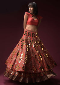 Coral Lehenga With Hand Embroidered Geometric Mirror Work And Plain Raw Silk Choli With Tassels On The Sleeves Online - Kalki Fashion