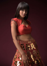 Coral Lehenga With Hand Embroidered Geometric Mirror Work And Plain Raw Silk Choli With Tassels On The Sleeves Online - Kalki Fashion