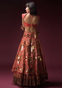 Coral Lehenga With Hand Embroidered Geometric Mirror Work And Plain Raw Silk Choli With Tassels On The Sleeves Online - Kalki Fashion