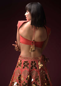 Coral Lehenga With Hand Embroidered Geometric Mirror Work And Plain Raw Silk Choli With Tassels On The Sleeves Online - Kalki Fashion