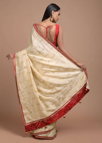 Cream Beige Saree In Dola Silk With Brocade Floral Buttis And Red Bandhani Design On The Pallu Online - Kalki Fashion