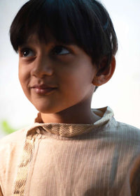 Kalki Boys Cream Kurta In Hand-woven Cotton Silk With Zari Enhanced Placket And Twisted Design At The Neck Love The World Today