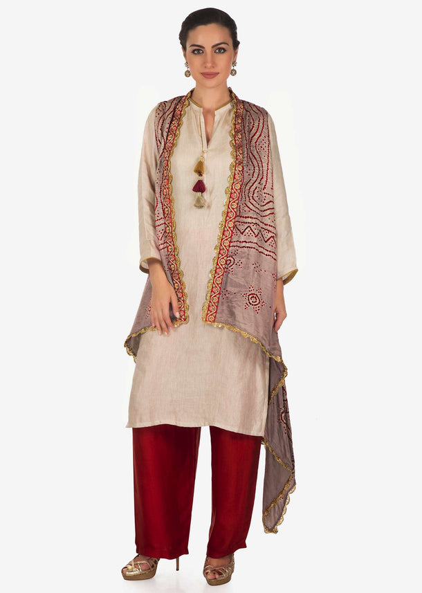 Cream suit with  tassel matched with bandhani jacket only on Kalki