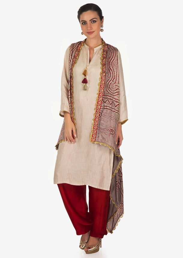 Cream suit with  tassel matched with bandhani jacket only on Kalki