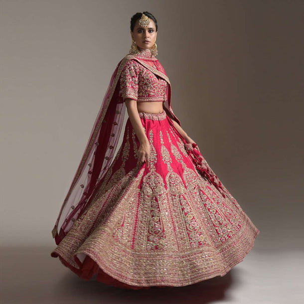 Dark Cranberry Pink Bridal Lehenga Choli In Raw Silk With Resham And Zari Embroidered Floral Kalis