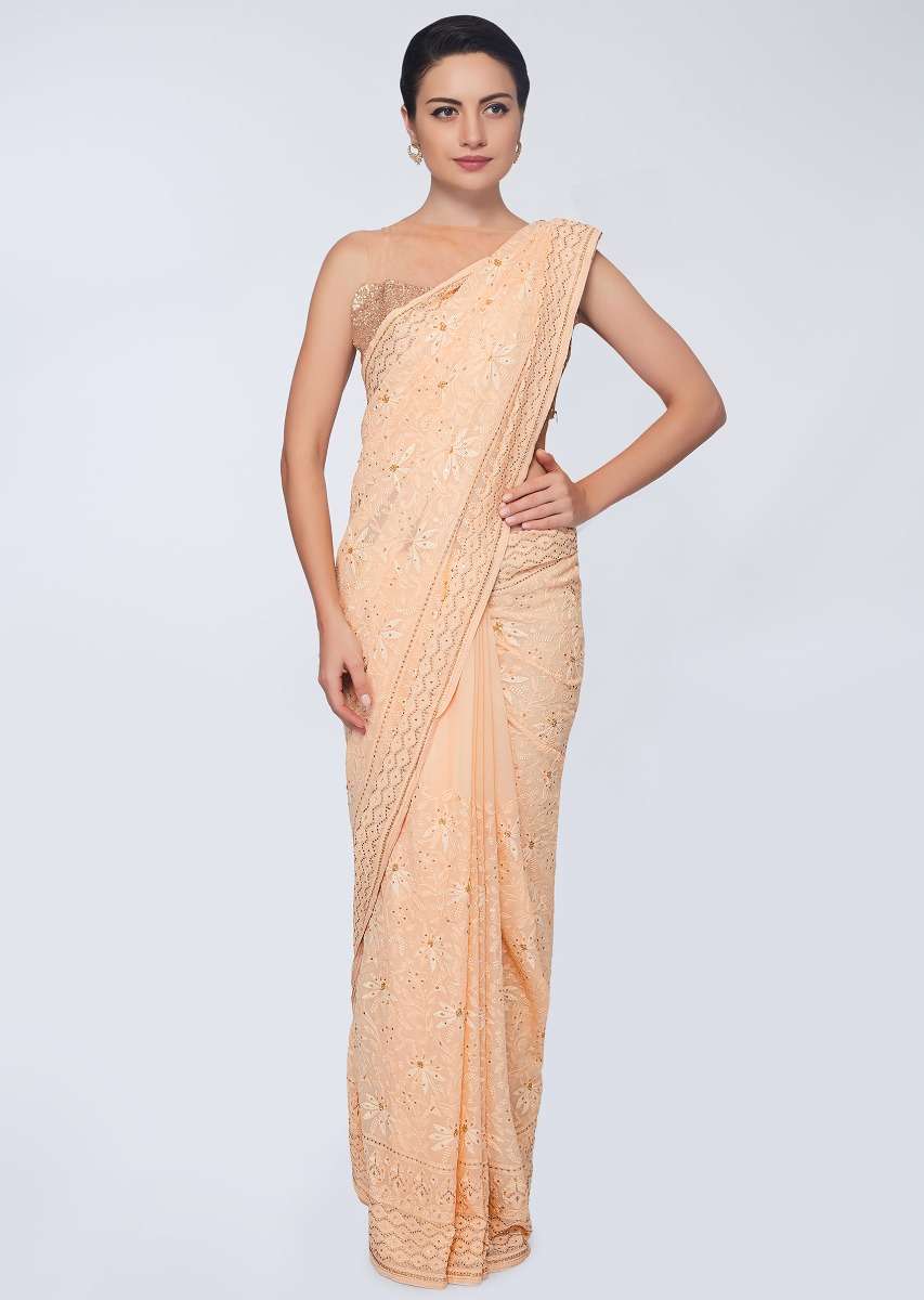 Dark cream georgette  saree featuring in floral embroidered jaal work