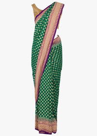 Dark green georgette saree with weaved butt