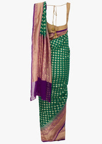 Dark green georgette saree with weaved butt