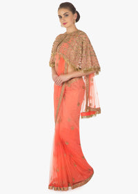 Dark peach net saree paired with a net embroidered cape