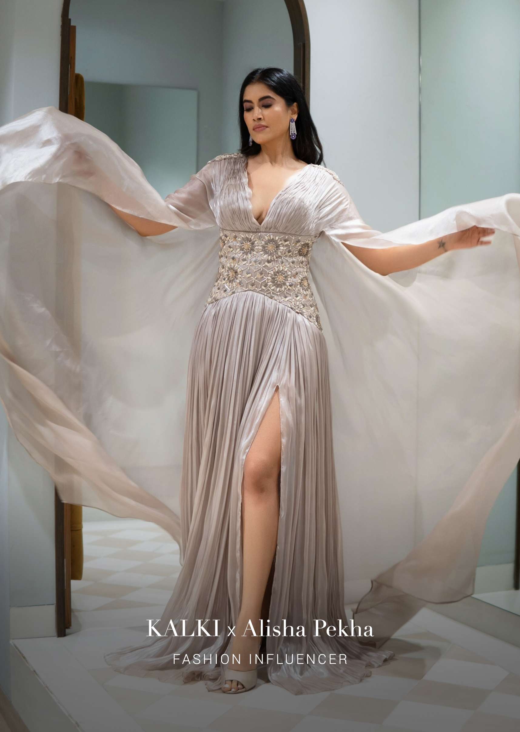 Doe Organza Gown With A Long Extended Cape Sleeves And A Plunging V Neckline